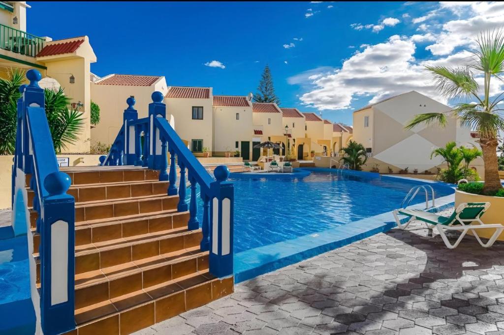 a villa with a swimming pool and stairs at House Harvey J53 Mareverde in Adeje