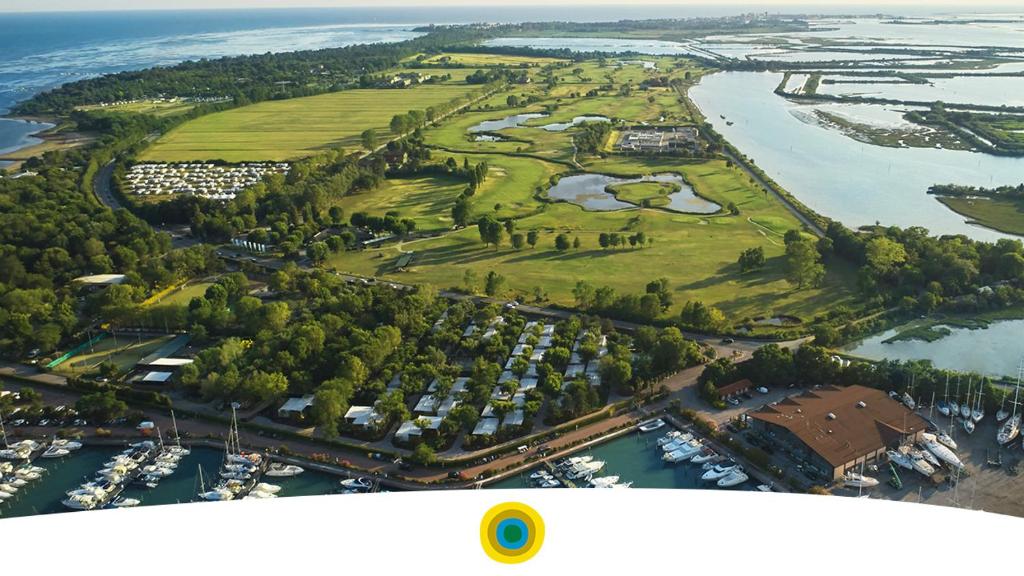 einen Luftblick auf einen Golfplatz neben einem Fluss in der Unterkunft Resort Tenuta Primero in Grado