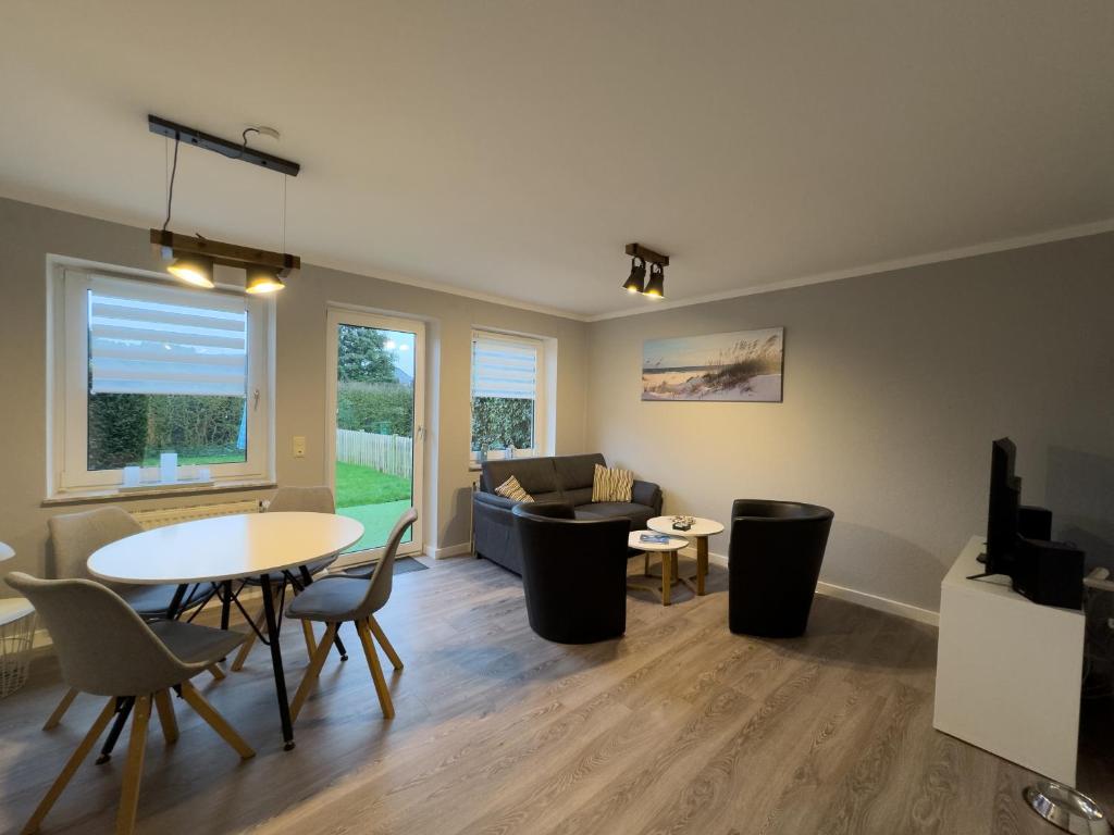 a living room with a table and a couch at Windfang 1 in Hooksiel in Wangerland