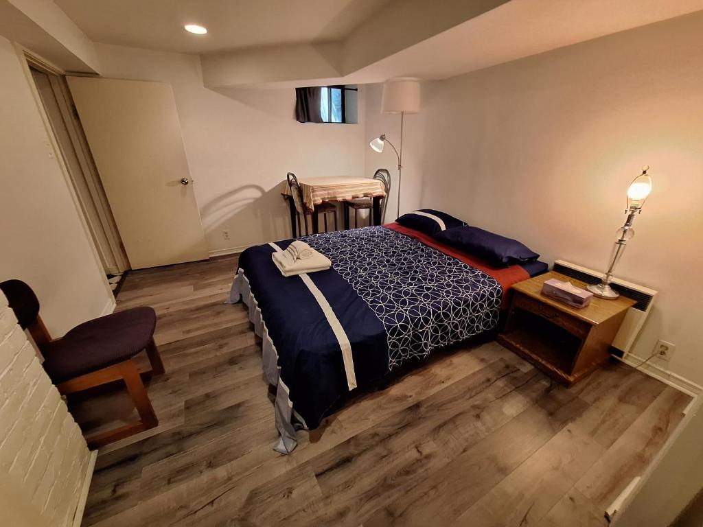 a bedroom with a bed and a table and a chair at Spacious Room next to Subway Line 1 Midtown Toronto in Toronto
