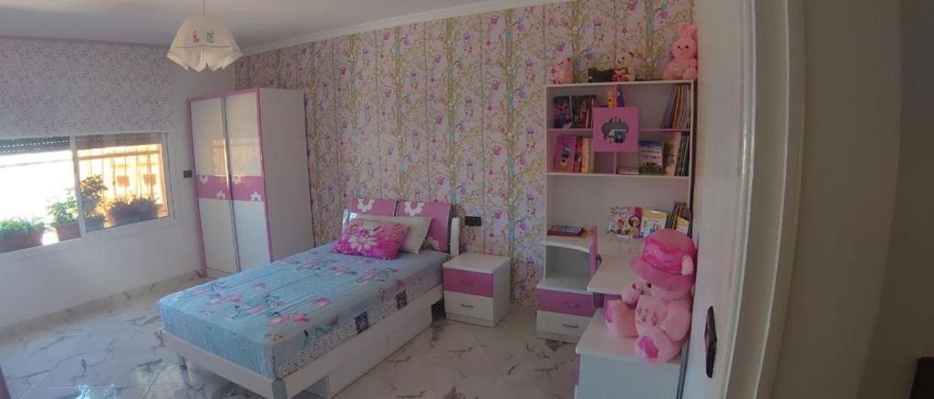 a childs bedroom with a bed and a dresser at My house 1 in Nador