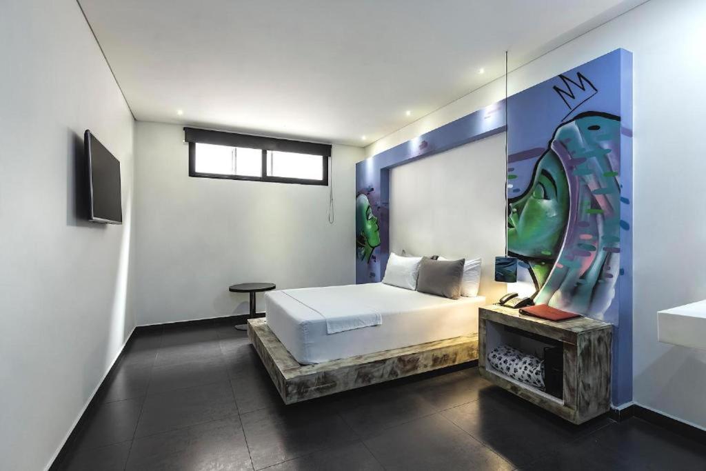Postel nebo postele na pokoji v ubytování Hotel Medellin Arte
