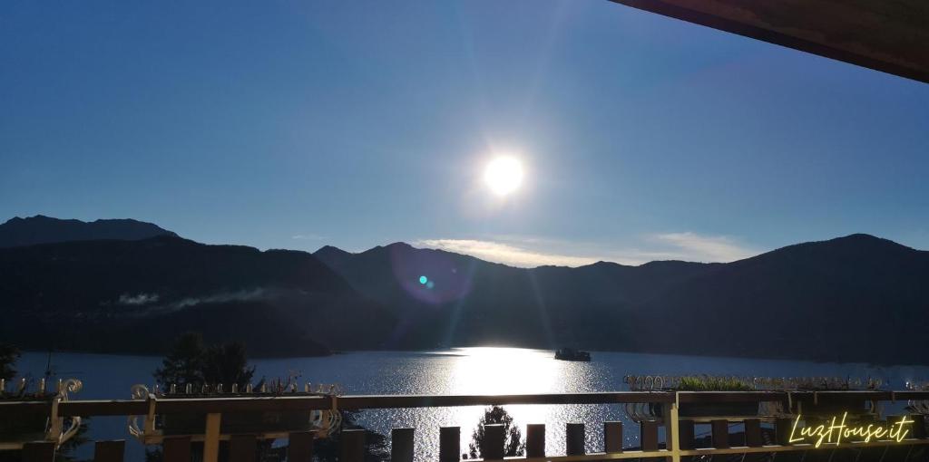 a view of the sun setting over a lake at Luz House in Tavernola Bergamasca