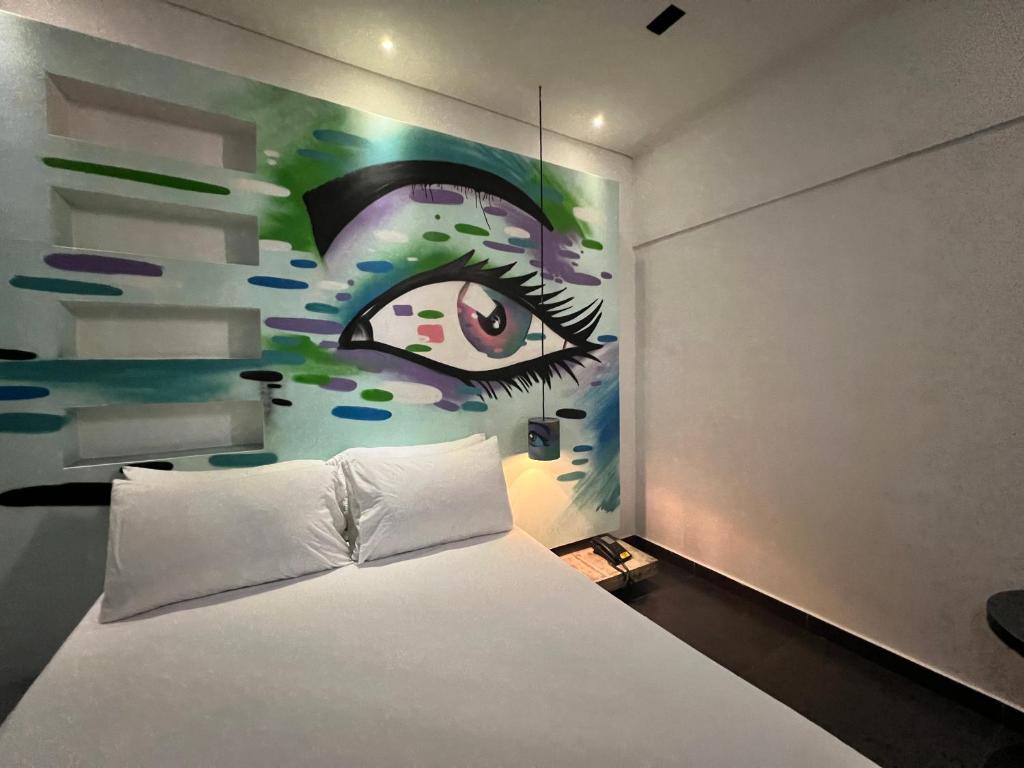 Postel nebo postele na pokoji v ubytování Hotel Medellin Arte