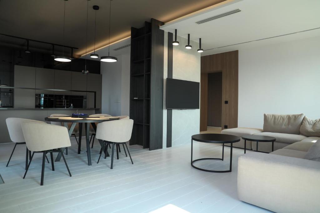 a kitchen and living room with a table and chairs at PREMIUM Apartment in center of Katowice in Katowice