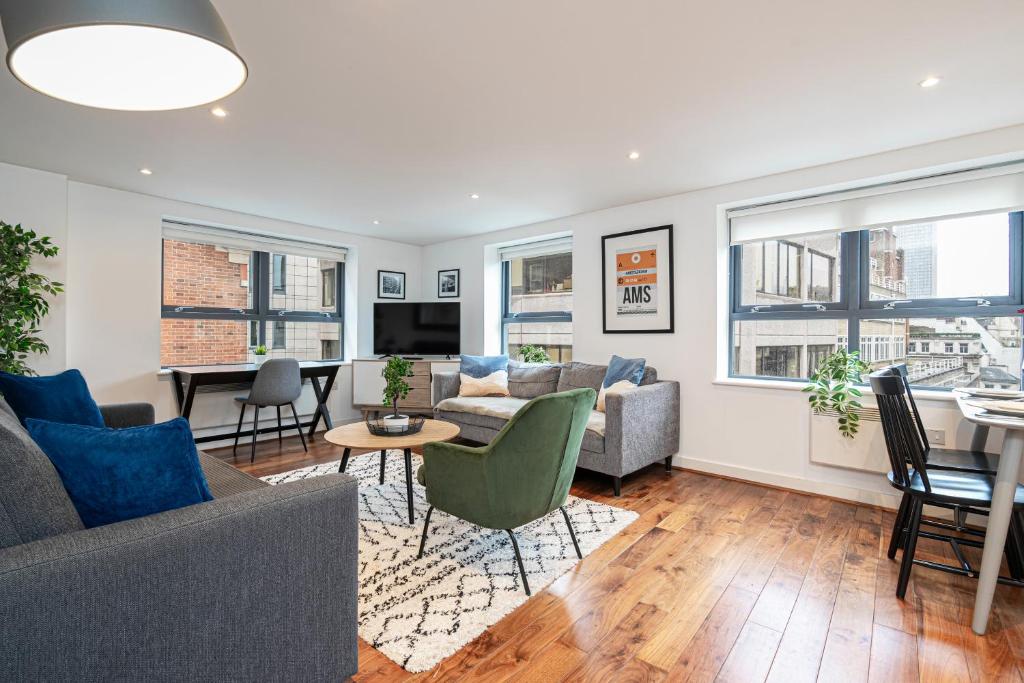 a living room with a couch and chairs and a table at Stay at Whitfield Street in London