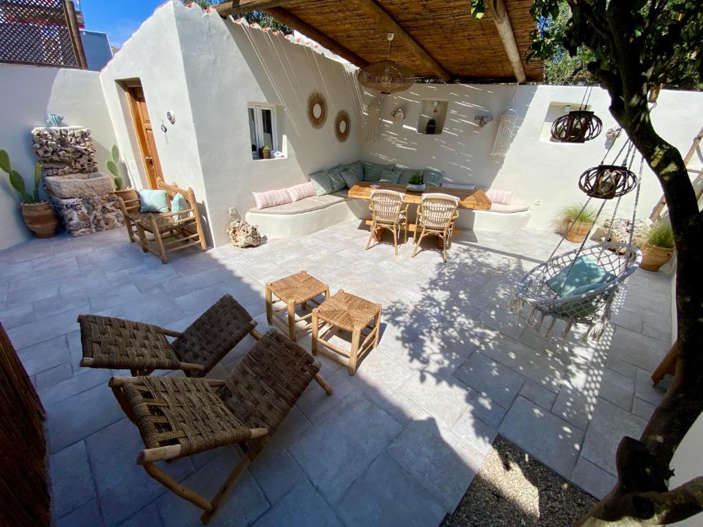 an overhead view of a patio with chairs and tables at koritos countryhouse in Agios Leon