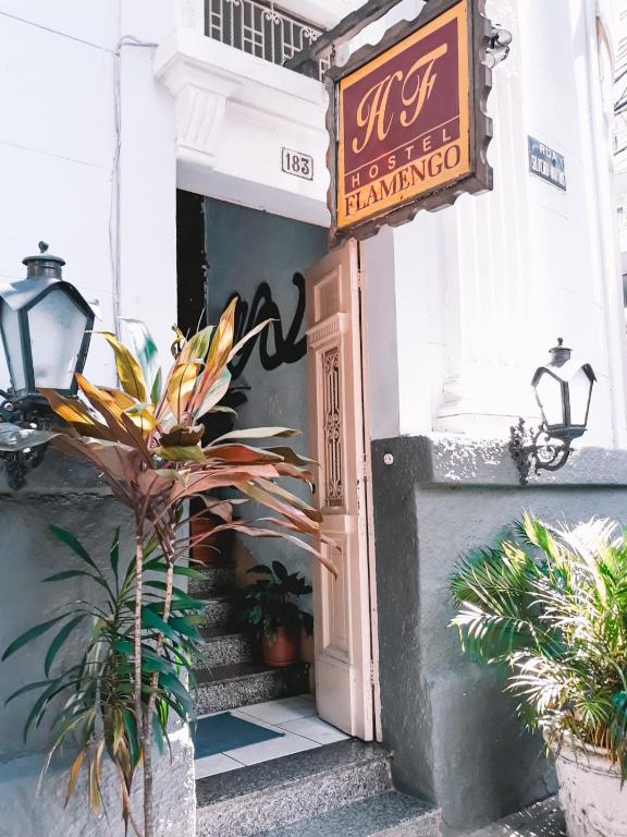 an entrance to a restaurant with a sign and plants at Hostel Flamengo in Rio de Janeiro
