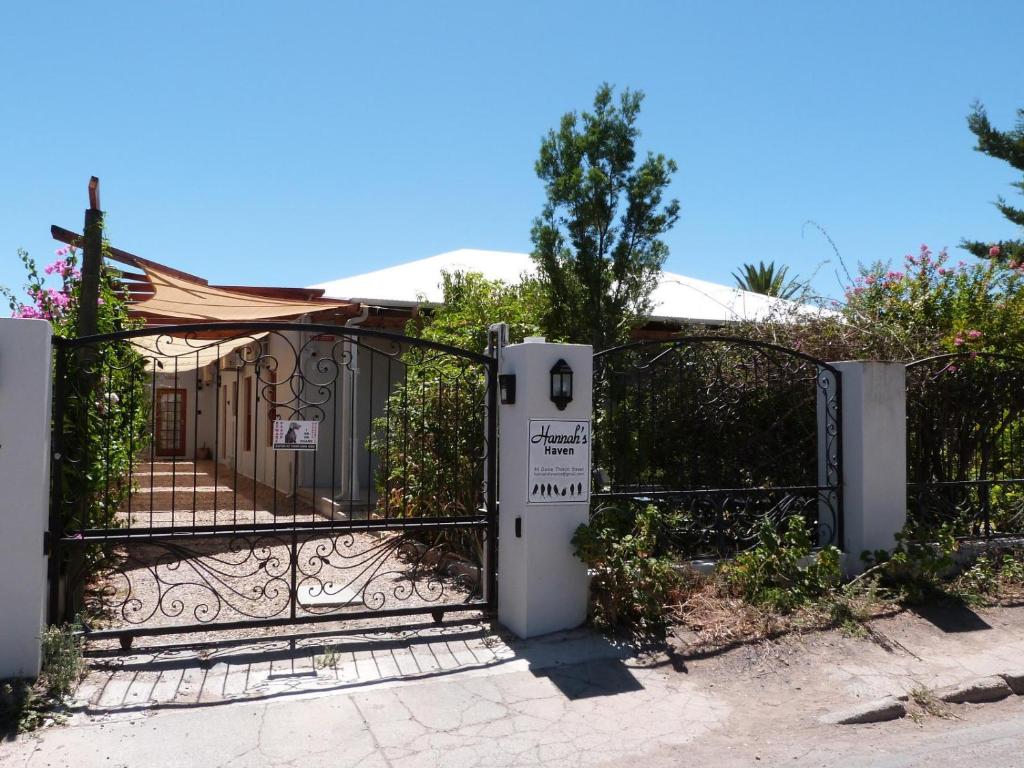 a gate with a sign in front of a house at Hannah's Haven in Beaufort West