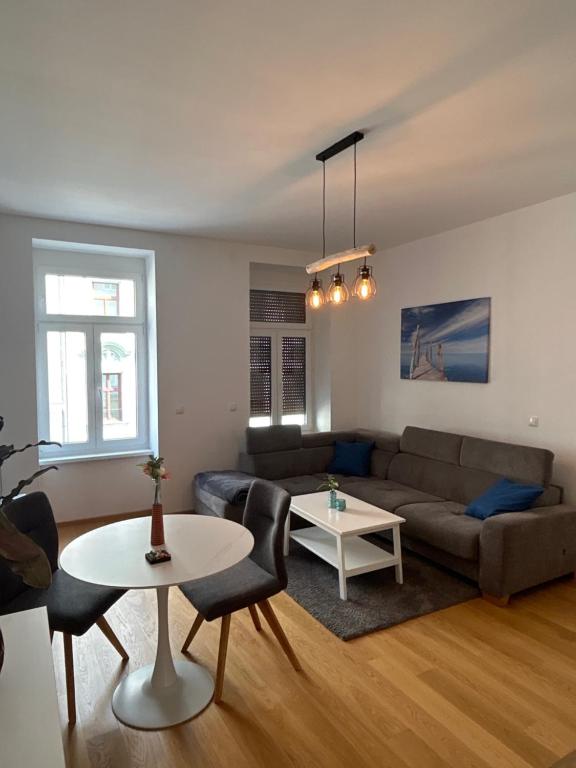 ein Wohnzimmer mit einem Sofa und einem Tisch in der Unterkunft Central Apartment 10 in Wien