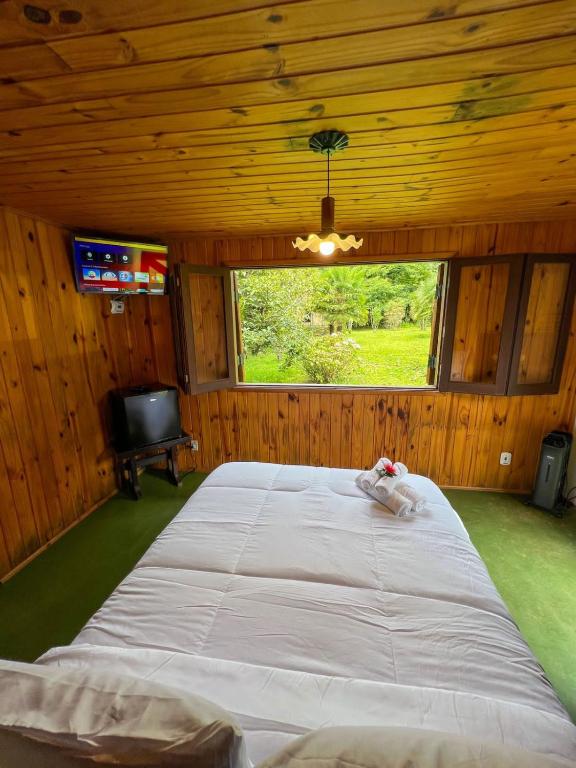 Cama ou camas em um quarto em Chalé Trento Monte Verde MG