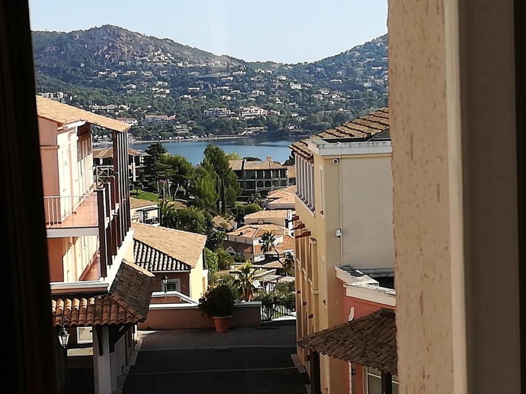 a view of a city from a balcony with buildings at Résidence le Village de Cap Esterel - maeva Home - Appartement 2 Pièces 5 Per 27 in Saint-Raphaël