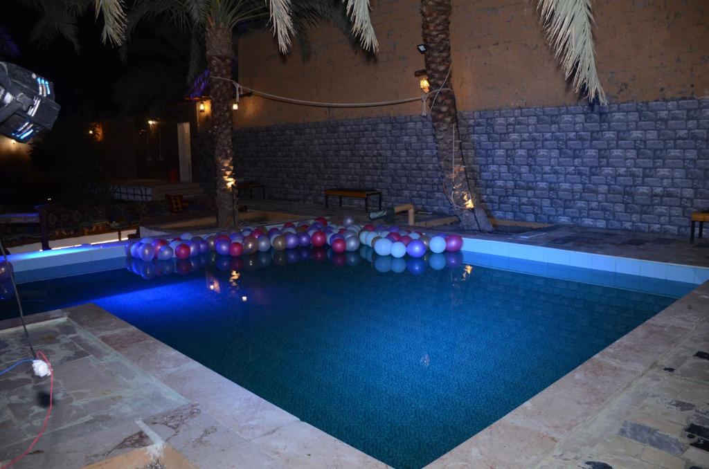 a swimming pool with a bunch of balloons in it at منتجع ريف خزيمة - الصباح in Al Madinah