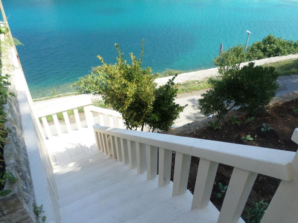 a white staircase with a view of the water at Apartment Mireja in Pučišća