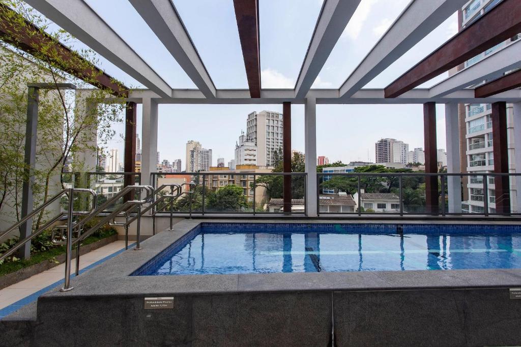 a swimming pool with a view of the city at Domy in Sao Paulo