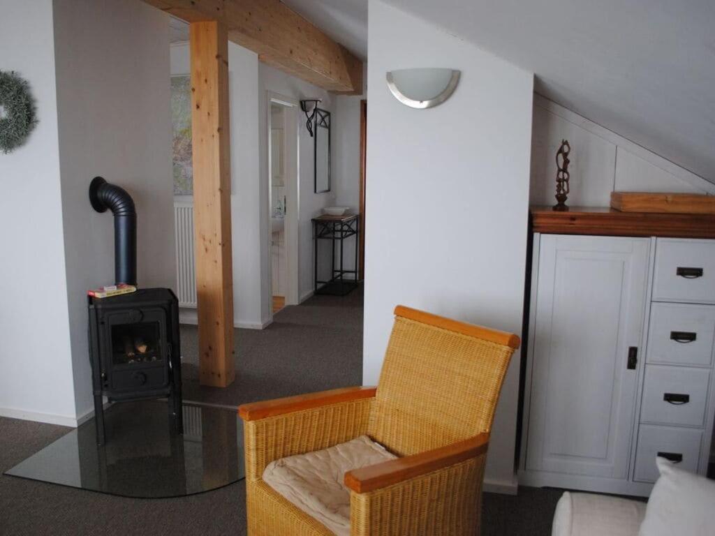 a living room with a chair and a wood stove at in the Berghanghäus"l Obersalzberg in Berchtesgaden