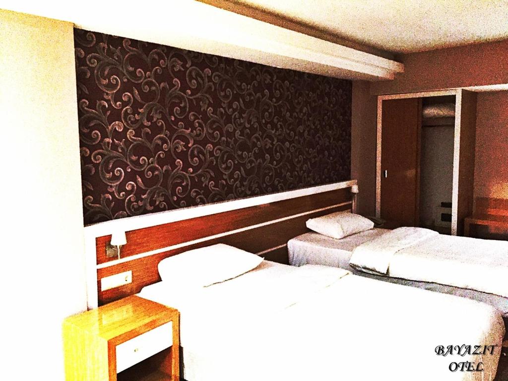 A bed or beds in a room at Bayazıt Hotel