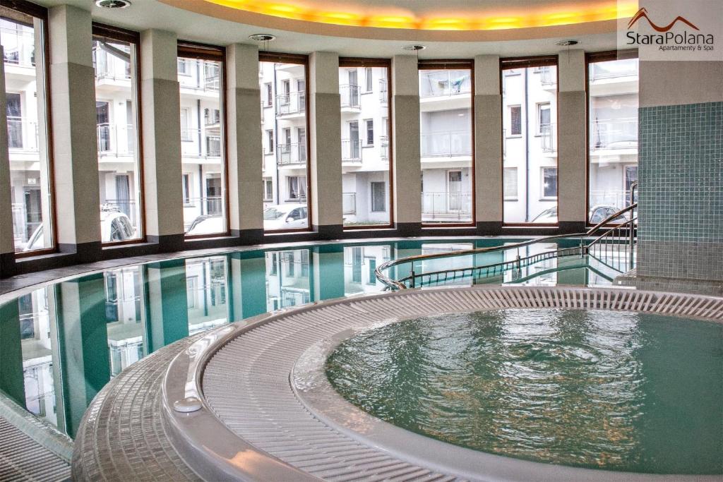 a swimming pool in the middle of a building at Apartamenty Stara Polana in Zakopane