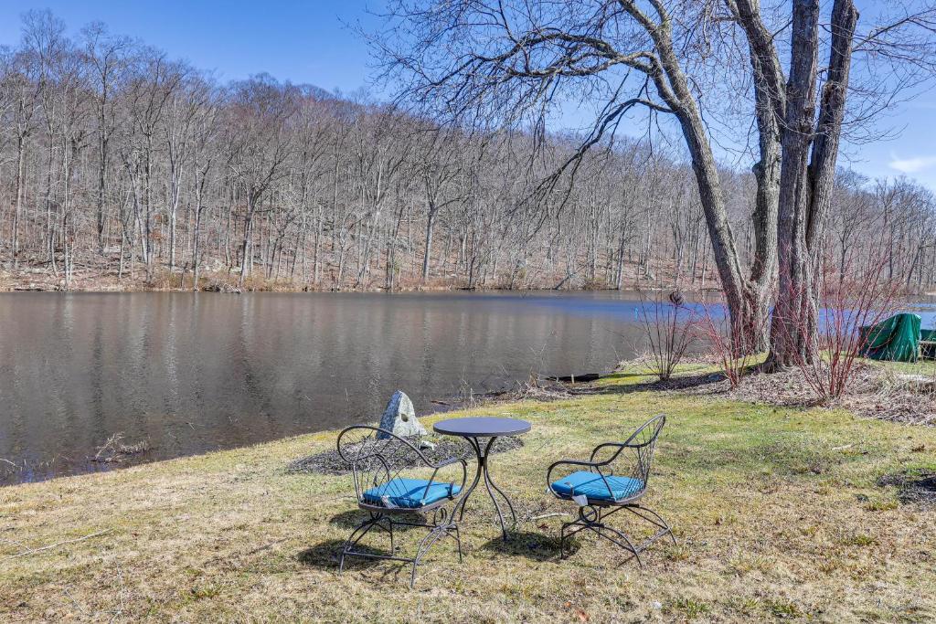 three chairs and a table in front of a lake at Charming Deep River Vacation Rental on Star Lake! in Deep River