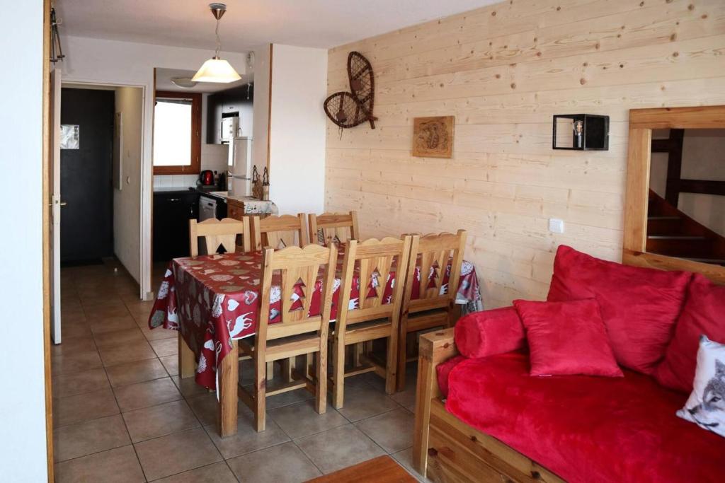salon z czerwoną kanapą i stołem w obiekcie Chalet La Combe D Or - Chalet mitoyen en résidence de standing MAE-3884 w mieście Le Mélézet
