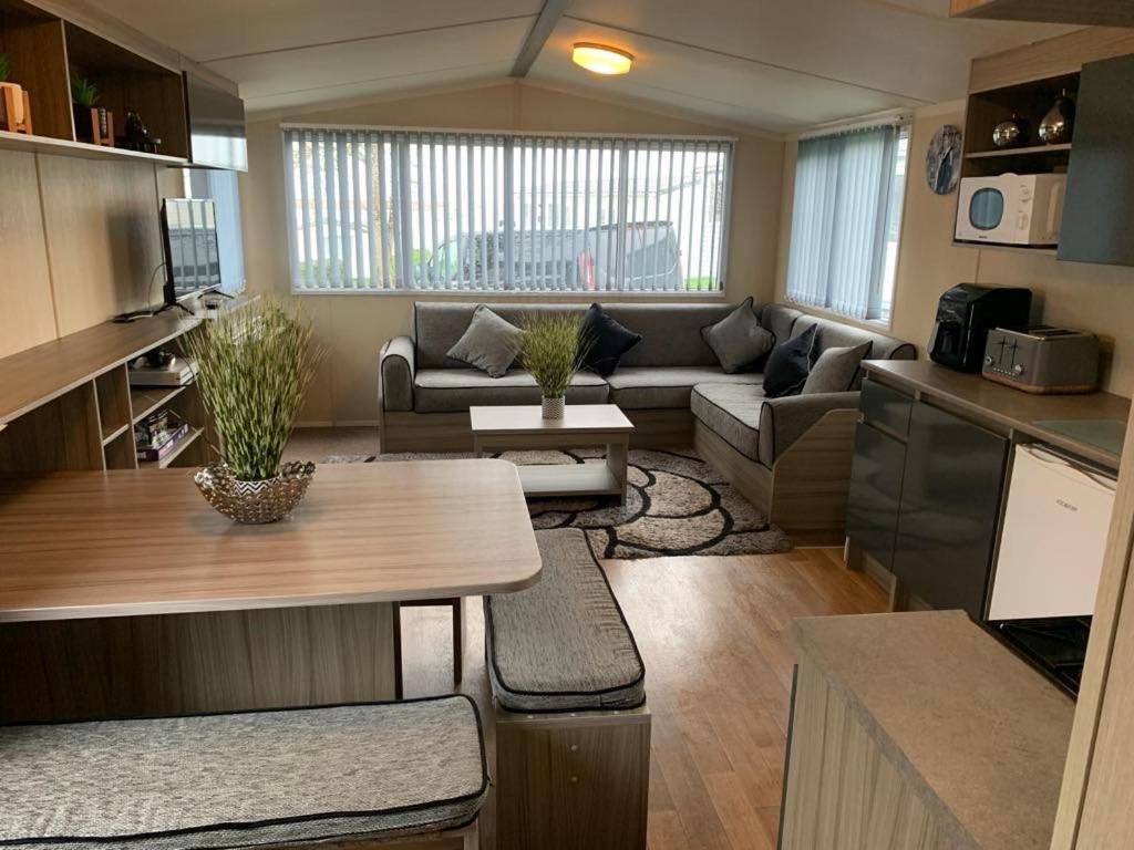 a living room with a couch and a table at Littlesea Haven Rachel's Retreat in Wyke Regis