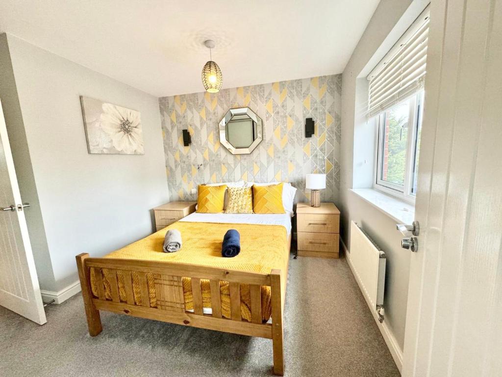 a bedroom with a large bed and a mirror at 3 Bedroom Home centrally located in Folkestone, great location for contractors or families with parking in Folkestone