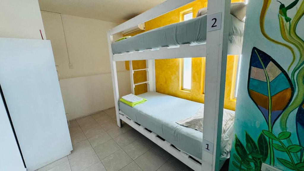 a small bedroom with a bunk bed in a room at La Luz Hostal Cancun in Cancún