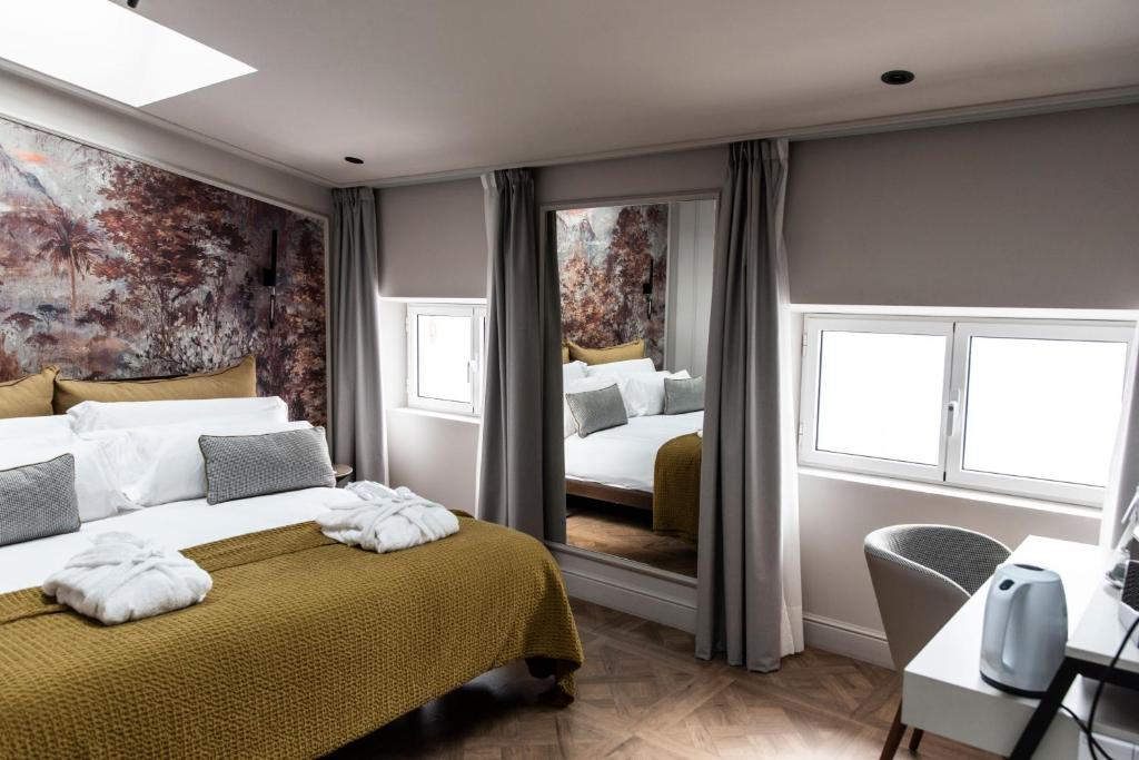 Postel nebo postele na pokoji v ubytování Soho Boutique Palacio de Pombo
