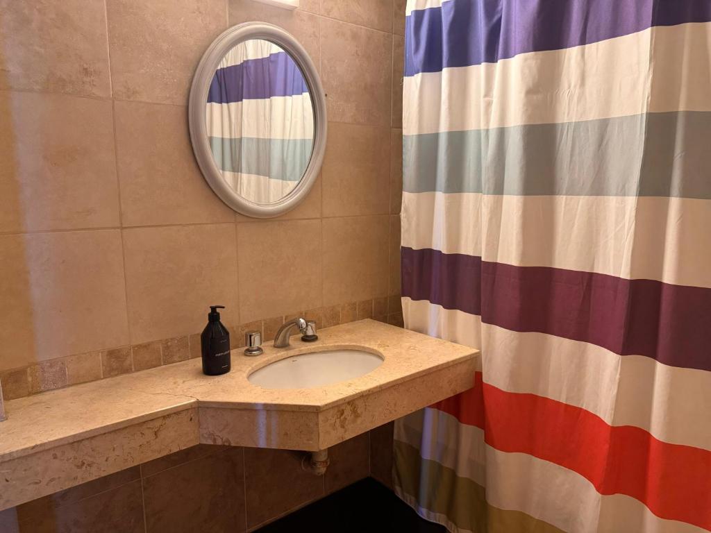 a bathroom with a sink and a mirror at Departamento completo en barrio sur! in San Miguel de Tucumán