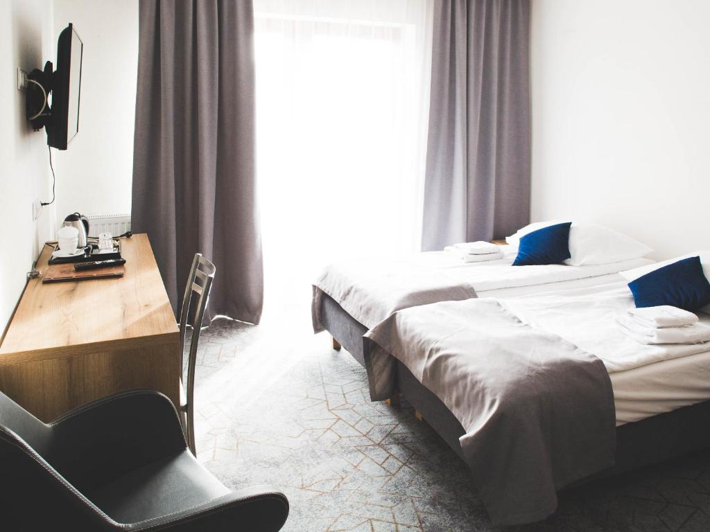 Postel nebo postele na pokoji v ubytování Hotel Beskidian