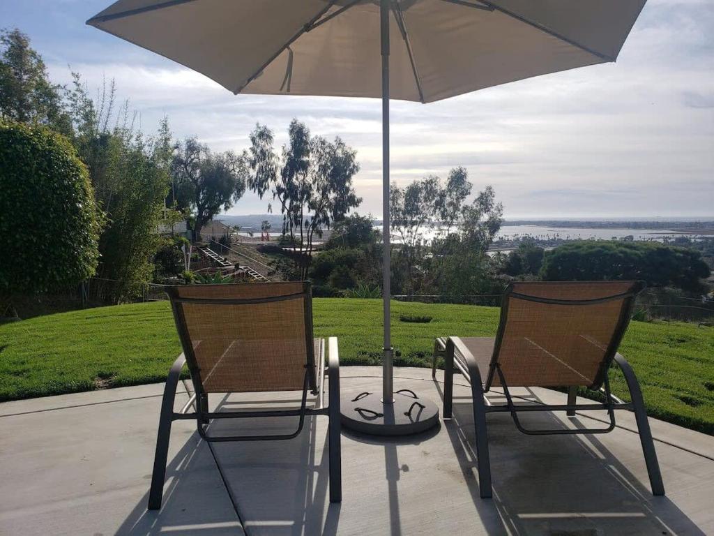two chairs and a table with an umbrella at Best Ocean & Bay Views in SD Large Backyard Air Conditioning in San Diego