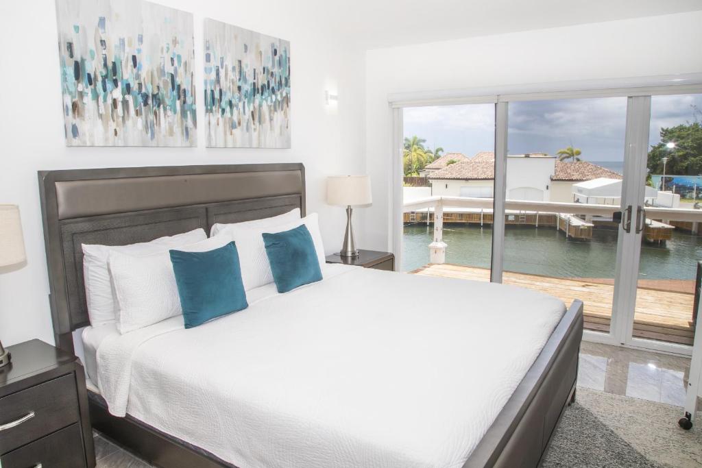 a bedroom with a bed and a view of a dock at 247C South Finger in Jolly Harbour