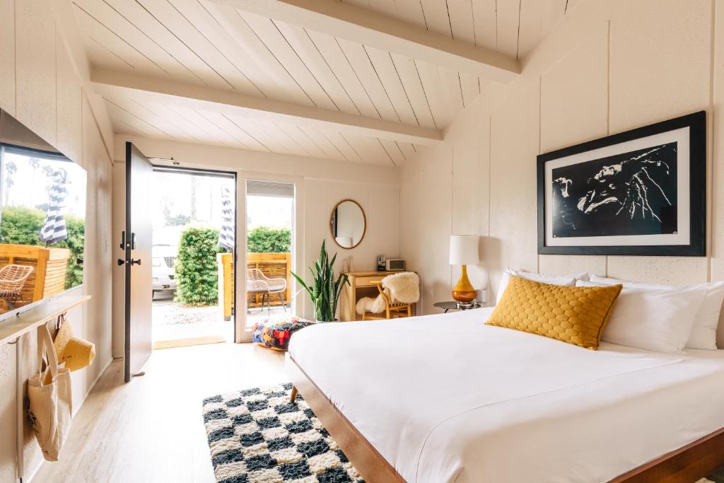 a bedroom with a large white bed in a room at The Green Room Hotel in Oceanside