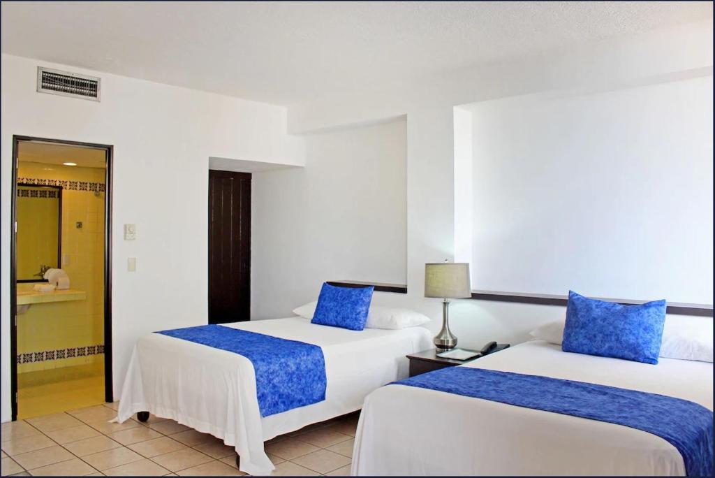 Postel nebo postele na pokoji v ubytování Hotel Delfín Vista Pier Beach Front