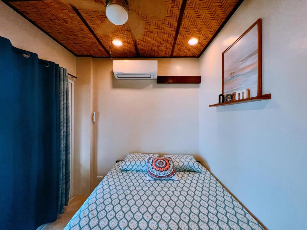 a bedroom with a bed in a room at Gloria's Beach House in Oslob