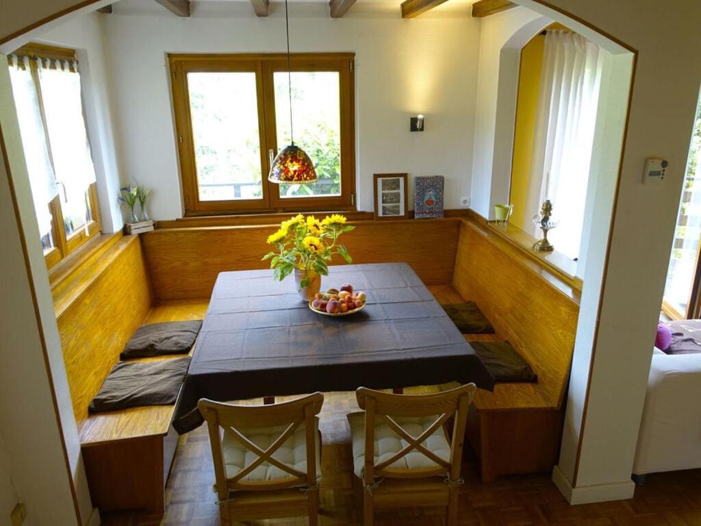 a dining room with a table with a bowl of fruit on it at Modern apartment in Soultzeren in Soultzeren
