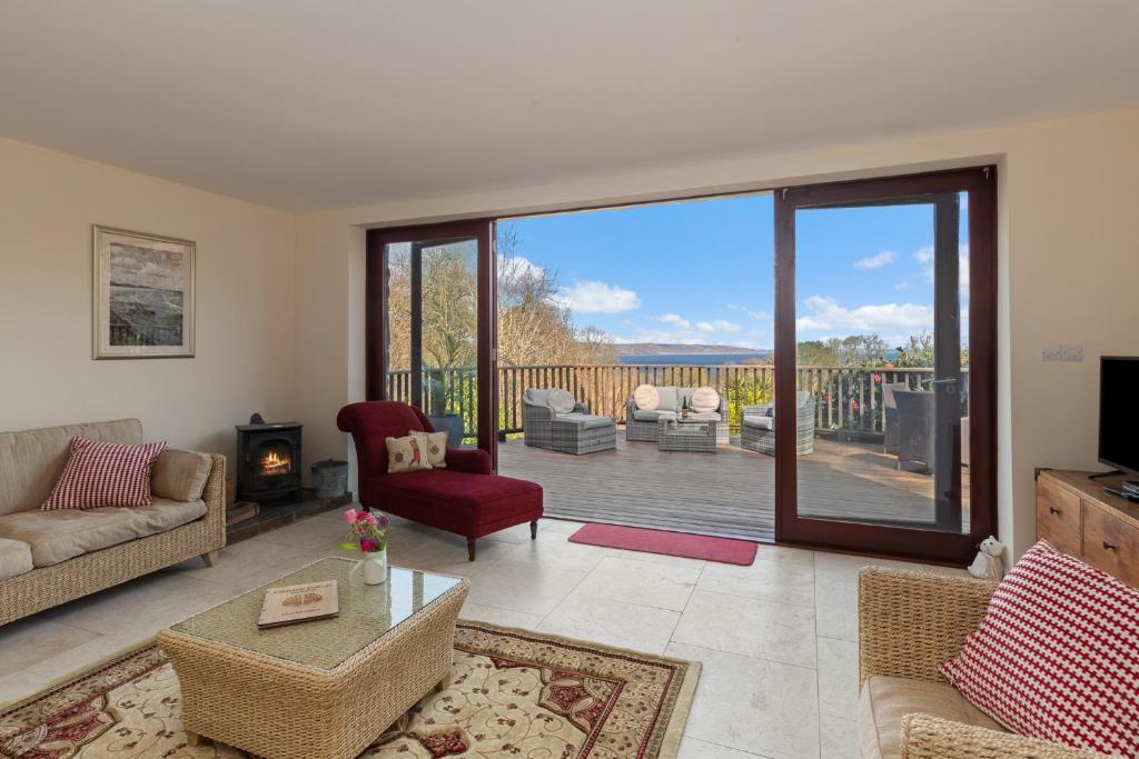 a living room with a view of a deck at Glendale Saundersfoot in Saundersfoot