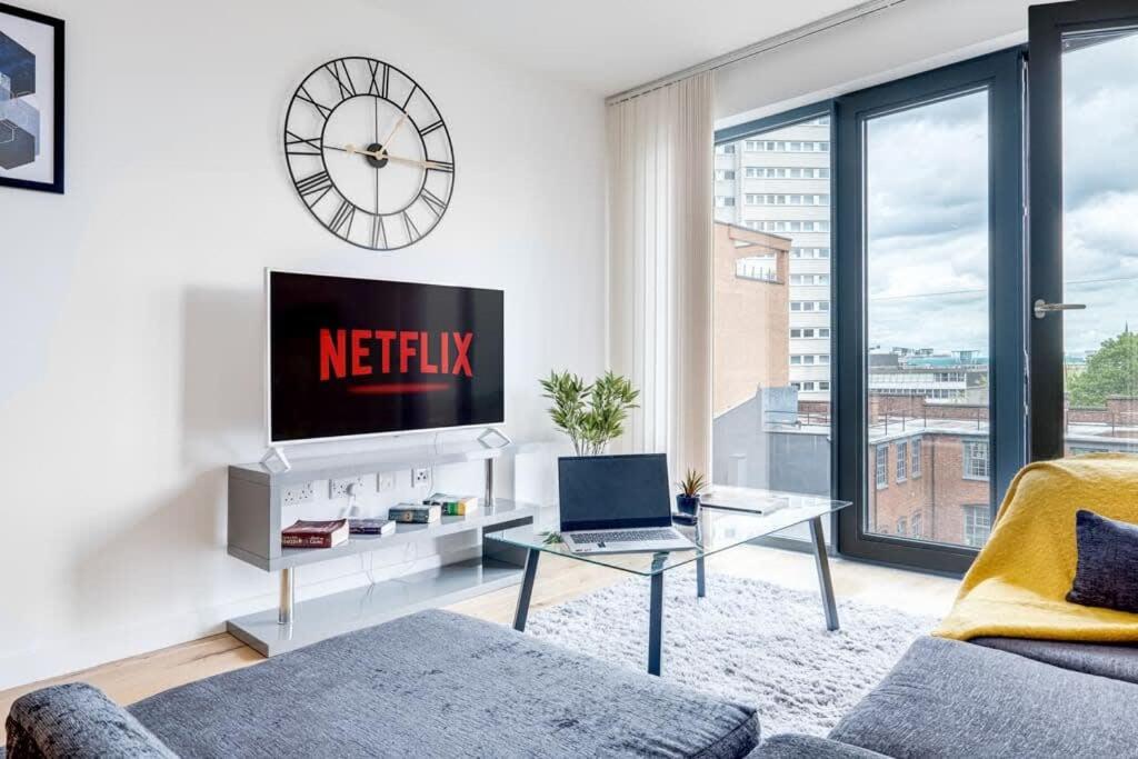 a living room with a tv and a large window at Apollo Luxury - Netflix - Fast WIFI- FREE PARKING in Birmingham