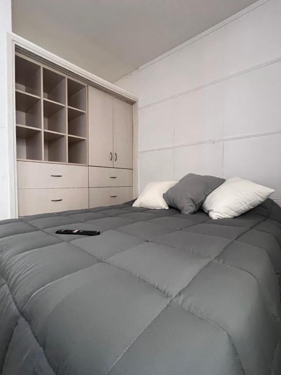a bedroom with a large bed with two pillows at Departamento PH 4 ambientes La perla a 5 cuadras de playa in Mar del Plata