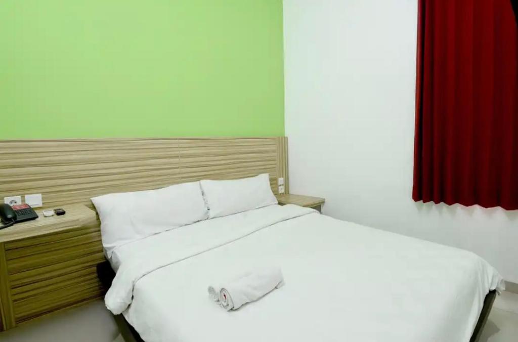 Postel nebo postele na pokoji v ubytování MIRA Inn Kayoon