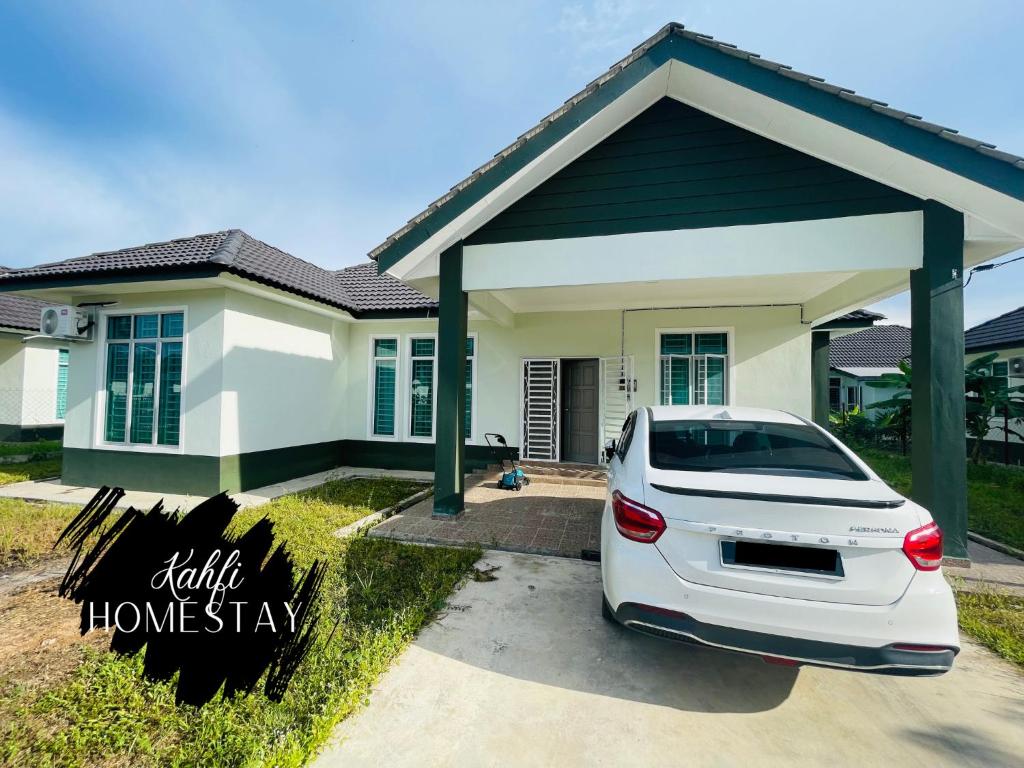 a white car parked in front of a house at Kahfi Homestay Tanah Merah, Kelantan in Tanah Merah
