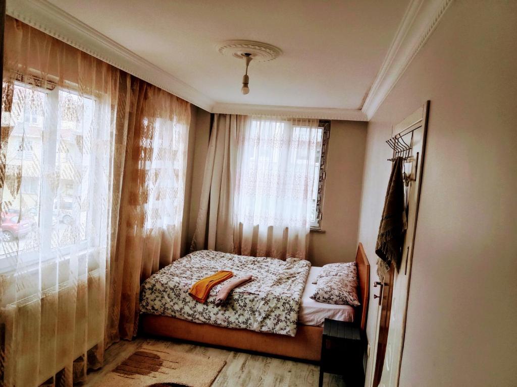 a small bedroom with a bed and a window at Airport forest villa hotel in Arnavutköy