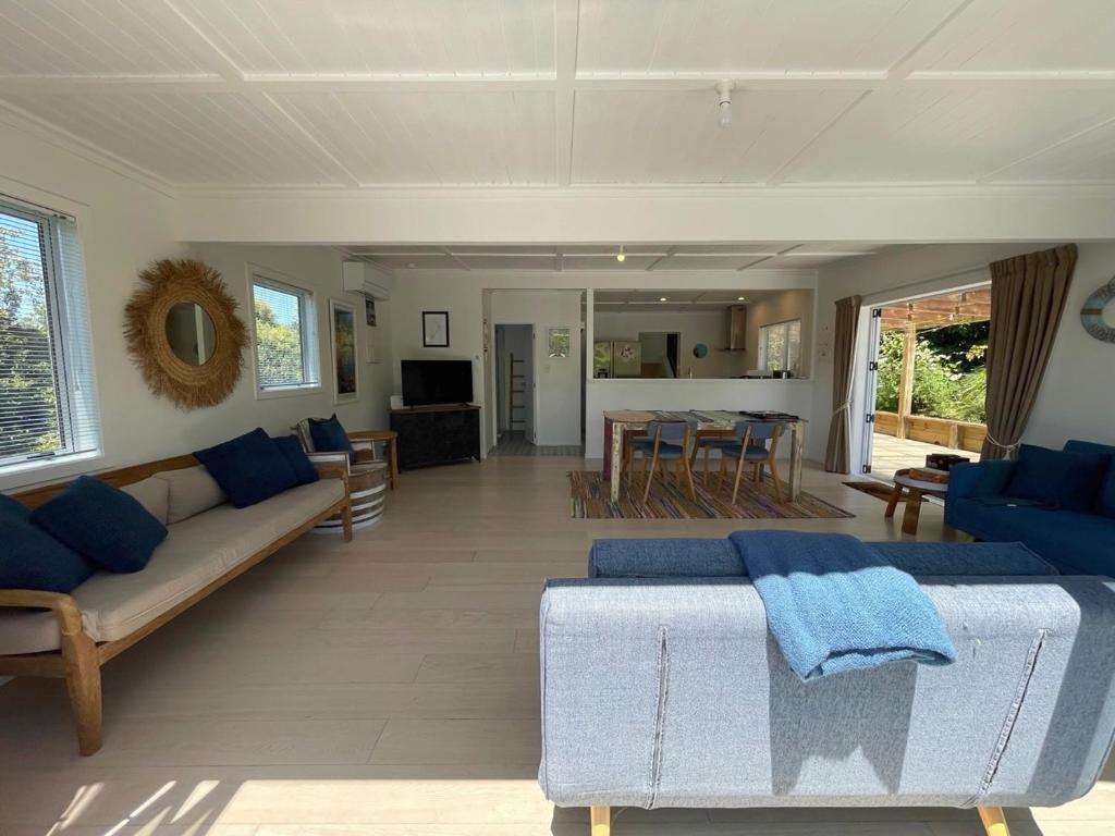 a living room with a couch and a table at Oneroa Village Oasis - Waiheke Escapes in Blackpool