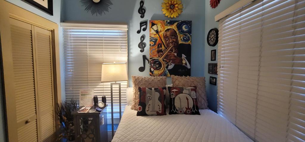 a bedroom with a bed with a poster on the wall at Jazzy Studio in a GREAT Location in New Orleans