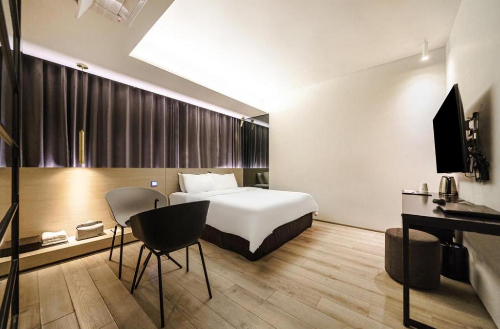 Postel nebo postele na pokoji v ubytování H Hotel Wangsimni