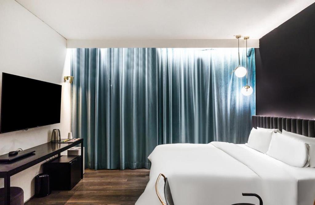 Postel nebo postele na pokoji v ubytování H Hotel Wangsimni