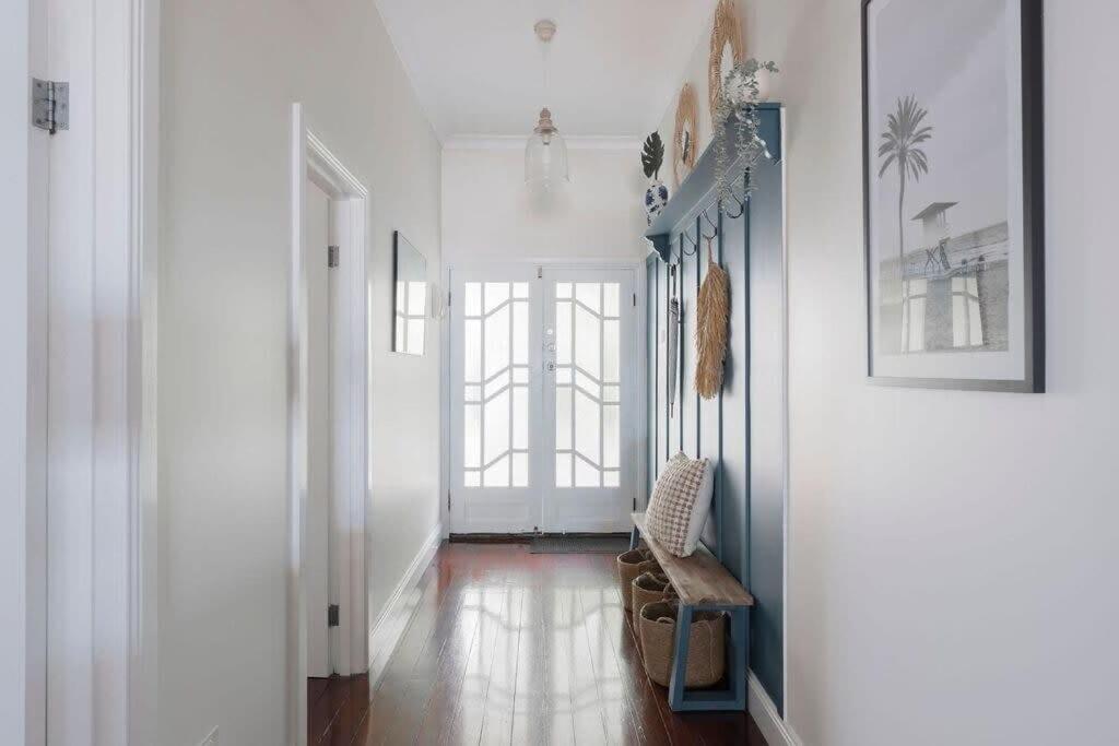 a hallway with a chair in a white room at View Point: Ocean Views & Near CBD in Burnie