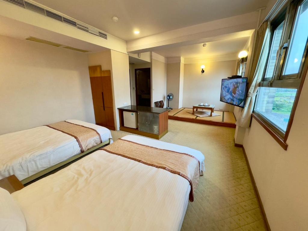 TV a/nebo společenská místnost v ubytování Tian Long Hotel
