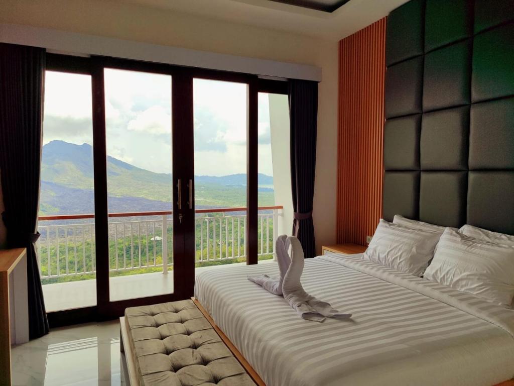 Säng eller sängar i ett rum på Batur view Homestay