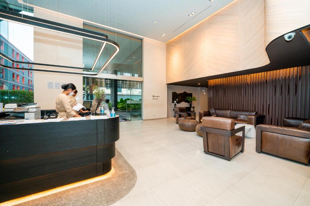 The reception area opens directly onto a compact, softly lit lounge.